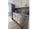 Modern kitchen with stainless steel appliances, granite countertops, and stylish cabinetry at 112 Village Ct, Woodstock, GA 30188