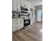 Well-lit kitchen with stainless steel appliances, sleek countertops, and modern cabinetry at 112 Village Ct, Woodstock, GA 30188