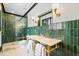 Glamorous bathroom featuring marble countertops, gold fixtures, and a tiled shower with glass door at 3146 Frontenac Ne Ct, Atlanta, GA 30319