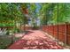 Backyard batting cage with a red dirt floor and netting, providing a great space for baseball practice at 3146 Frontenac Ne Ct, Atlanta, GA 30319