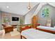 A bedroom under the eaves with natural light, a seating area, and two beds for guests at 3146 Frontenac Ne Ct, Atlanta, GA 30319