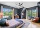 Bedroom featuring hardwood floors, many windows for natural light, and a comfy bed with blue accents at 3146 Frontenac Ne Ct, Atlanta, GA 30319
