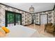 Bedroom with hardwood floors, decorative wallpaper, a king bed, and access to a backyard porch at 3146 Frontenac Ne Ct, Atlanta, GA 30319