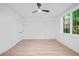 Bright bedroom features new flooring, a modern ceiling fan, and natural light from the windows at 3146 Frontenac Ne Ct, Atlanta, GA 30319