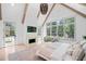 Bright bedroom with fireplace, large windows, vaulted ceilings, wood beams, and a decorative chandelier at 3146 Frontenac Ne Ct, Atlanta, GA 30319