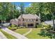 Stately brick home with manicured lawn, a covered porch, and a stone walkway leading to the entrance at 3146 Frontenac Ne Ct, Atlanta, GA 30319