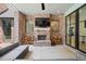 Inviting outdoor area with fireplace, TV, comfortable seating, and brick accents at 3146 Frontenac Ne Ct, Atlanta, GA 30319