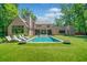 Beautiful backyard features a large pool with lounge chairs and lush green landscaping at 3146 Frontenac Ne Ct, Atlanta, GA 30319