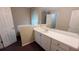 Bathroom vanity with white cabinets, a mirror, and neutral walls at 3679 Seabass Rd, Decatur, GA 30034
