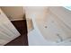 Large white bathtub with tile surround and chrome fixtures in tiled bathroom at 3679 Seabass Rd, Decatur, GA 30034