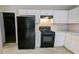 Kitchen featuring white cabinets, black appliances, and speckled gray countertops at 3679 Seabass Rd, Decatur, GA 30034