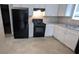 Kitchen featuring white cabinets, black appliances, and light countertops at 3679 Seabass Rd, Decatur, GA 30034