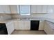 Kitchen with white cabinets and countertops, featuring a stainless steel double sink at 3679 Seabass Rd, Decatur, GA 30034