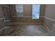 Empty room featuring paneled wall and two windows at 3679 Seabass Rd, Decatur, GA 30034