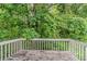 Back deck overlooking lush green trees and foliage at 6114 Leverett Dr, Lithonia, GA 30038
