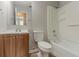 The bathroom showcases a vanity, toilet, and shower-tub combination with bright lighting at 6114 Leverett Dr, Lithonia, GA 30038
