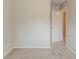 Bedroom has neutral walls and carpet with access to other rooms through an open door at 6114 Leverett Dr, Lithonia, GA 30038