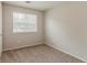Bedroom showcases neutral walls, carpet, and a window offering natural light at 6114 Leverett Dr, Lithonia, GA 30038