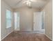 This bedroom offers neutral walls, carpet, and a ceiling fan, with views of additional rooms at 6114 Leverett Dr, Lithonia, GA 30038