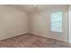 Bedroom includes neutral walls and carpet with a window for ample natural lighting at 6114 Leverett Dr, Lithonia, GA 30038