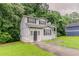 Quaint two-story home has a cozy front porch, grassy lawn, and delightful curb appeal at 6114 Leverett Dr, Lithonia, GA 30038