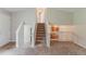 Sunlit foyer features a staircase and open view into the kitchen at 6114 Leverett Dr, Lithonia, GA 30038