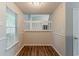 Bright foyer with hardwood floors and natural light from window at 6114 Leverett Dr, Lithonia, GA 30038