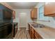 Well-lit kitchen with updated appliances, ample counter space, and wood flooring at 6114 Leverett Dr, Lithonia, GA 30038