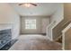 Bright living room featuring a fireplace and staircase access at 6114 Leverett Dr, Lithonia, GA 30038