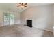 Spacious living room with a fireplace and sliding glass doors to backyard at 6114 Leverett Dr, Lithonia, GA 30038