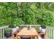 Outdoor patio with dining table and surrounding greenery provides a tranquil setting at 6114 Leverett Dr, Lithonia, GA 30038