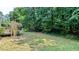 Lush backyard featuring a deck and mature trees providing shade and privacy at 6385 Southland Forest Dr, Stone Mountain, GA 30087