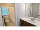 Well-lit bathroom with a single sink vanity, toilet and tub with shower at 6385 Southland Forest Dr, Stone Mountain, GA 30087