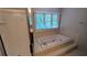 The bright bathroom features a tiled shower with a glass door and a soaking tub with a garden window at 6385 Southland Forest Dr, Stone Mountain, GA 30087