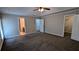 Spacious bedroom features carpet flooring and access to en-suite bathroom and closet at 6385 Southland Forest Dr, Stone Mountain, GA 30087