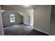 Spacious bedroom features neutral walls and carpeting, and dormer window letting in natural light at 6385 Southland Forest Dr, Stone Mountain, GA 30087