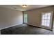 The bedroom has neutral walls and carpeting, and two windows letting in natural light at 6385 Southland Forest Dr, Stone Mountain, GA 30087