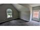 Comfortable bedroom features neutral walls and carpeting, and a large, arched window letting in natural light at 6385 Southland Forest Dr, Stone Mountain, GA 30087