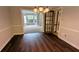 Elegant dining room boasts beautiful hardwood floors, chair rail, and chandelier at 6385 Southland Forest Dr, Stone Mountain, GA 30087
