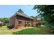 Spacious brick home featuring a large yard, mature landscaping, and multiple windows at 6385 Southland Forest Dr, Stone Mountain, GA 30087