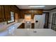 Charming kitchen features white appliances, tile countertops, and rich wood cabinetry at 6385 Southland Forest Dr, Stone Mountain, GA 30087