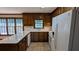 Functional kitchen featuring bright white appliances, tile floors and wooden cabinetry at 6385 Southland Forest Dr, Stone Mountain, GA 30087