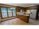 Bright eat-in kitchen features rich wood cabinets, tile floors, and a breakfast bar at 6385 Southland Forest Dr, Stone Mountain, GA 30087