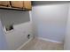 Compact laundry room with tile flooring and hook ups at 6385 Southland Forest Dr, Stone Mountain, GA 30087