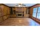 Spacious living room with brick fireplace, built-in shelving, and hardwood floors at 6385 Southland Forest Dr, Stone Mountain, GA 30087