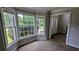 Bright living room featuring a large bay window and neutral carpeting at 6385 Southland Forest Dr, Stone Mountain, GA 30087