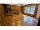 Cozy living room with brick fireplace, built-in bookshelves, and gleaming wood floors at 6385 Southland Forest Dr, Stone Mountain, GA 30087
