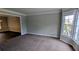 Bright living room features neutral carpeting and a large bay window at 6385 Southland Forest Dr, Stone Mountain, GA 30087