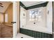 Bathroom boasts a tiled tub and shower combo with green accent tiles at 13 Cliff Ct, Villa Rica, GA 30180
