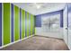 Bedroom featuring vertical blue and green stripes, a ceiling fan, and plush carpeting at 13 Cliff Ct, Villa Rica, GA 30180
